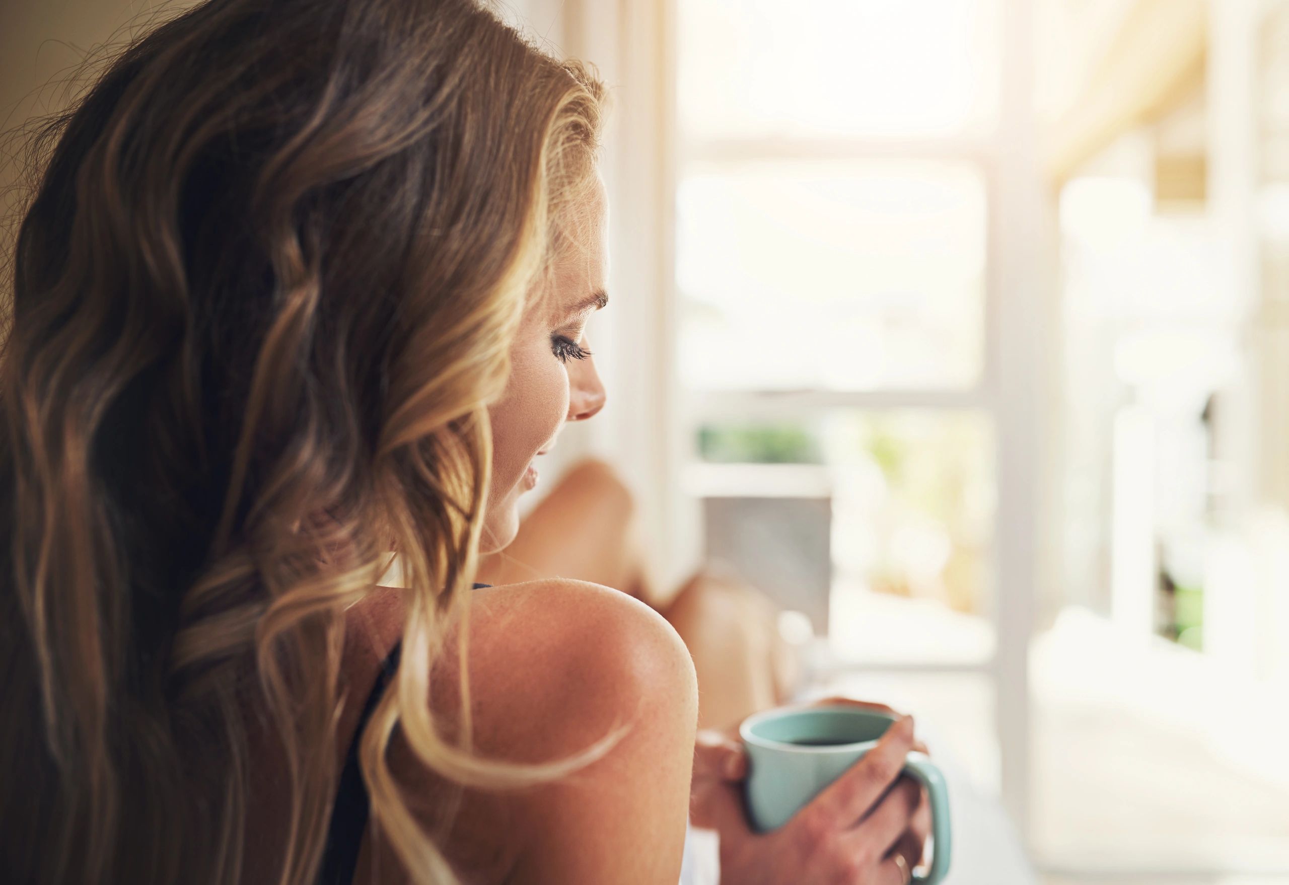 Relaxed woman enjoying a quiet coffee moment at home