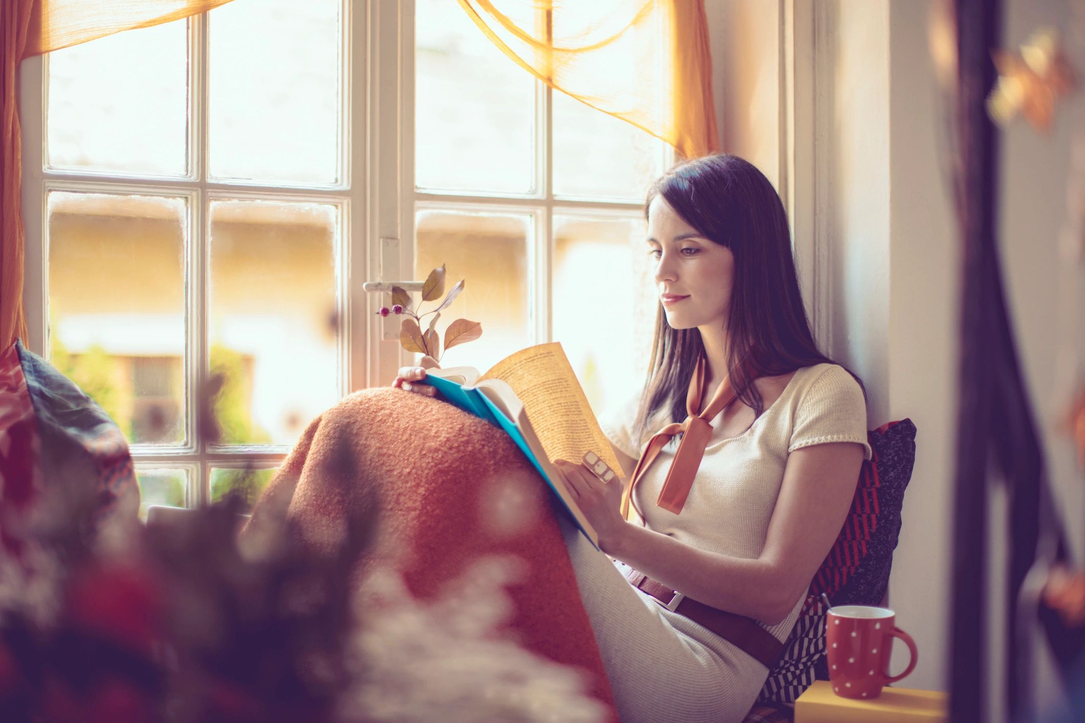 Woman in a cozy autumn setting reflecting quietly